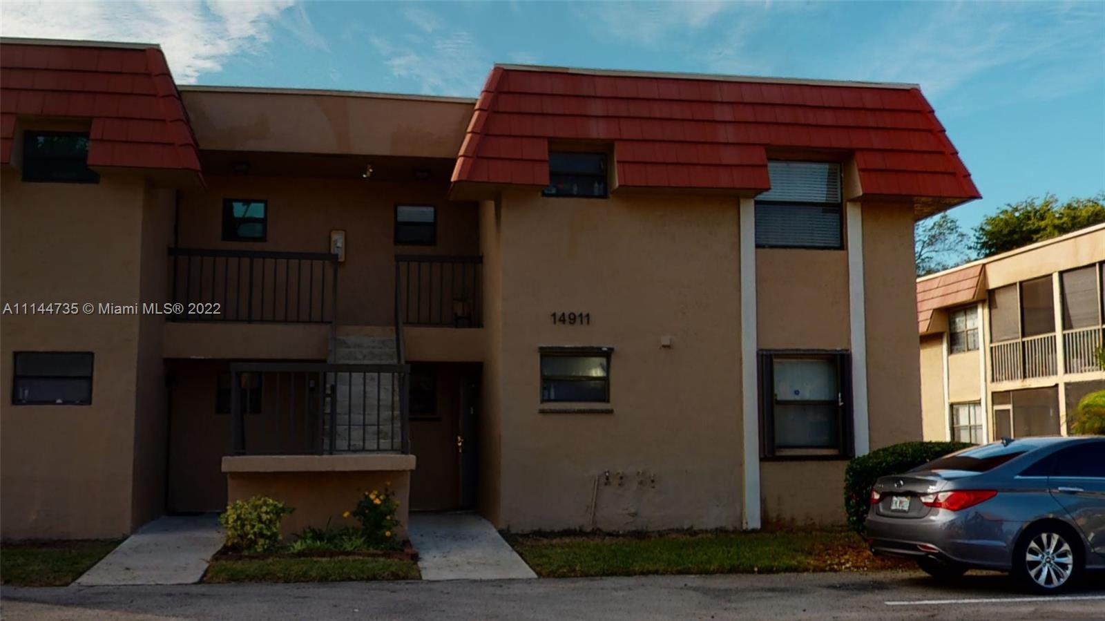 14911 Southwest 104th Street, Unit 1722 Miami, FL 33196 - Photo 6 of 29 a view of a car park in front of building