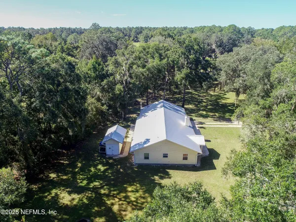 a view of a houses with a lot of trees