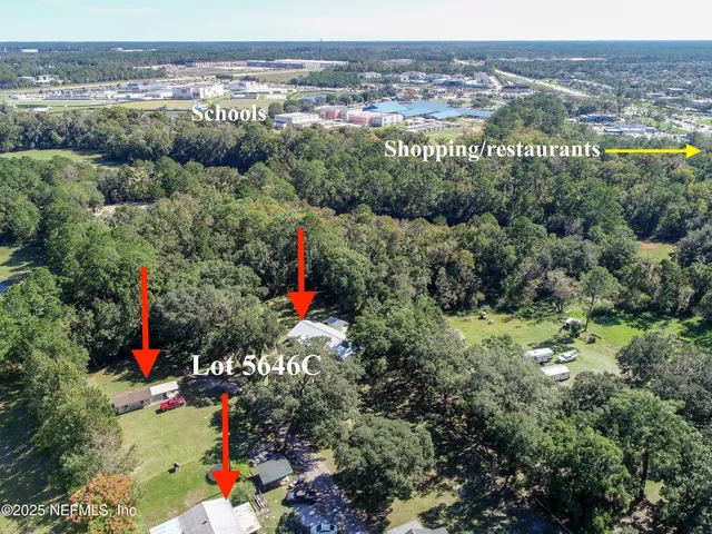 an aerial view of a houses with a yard