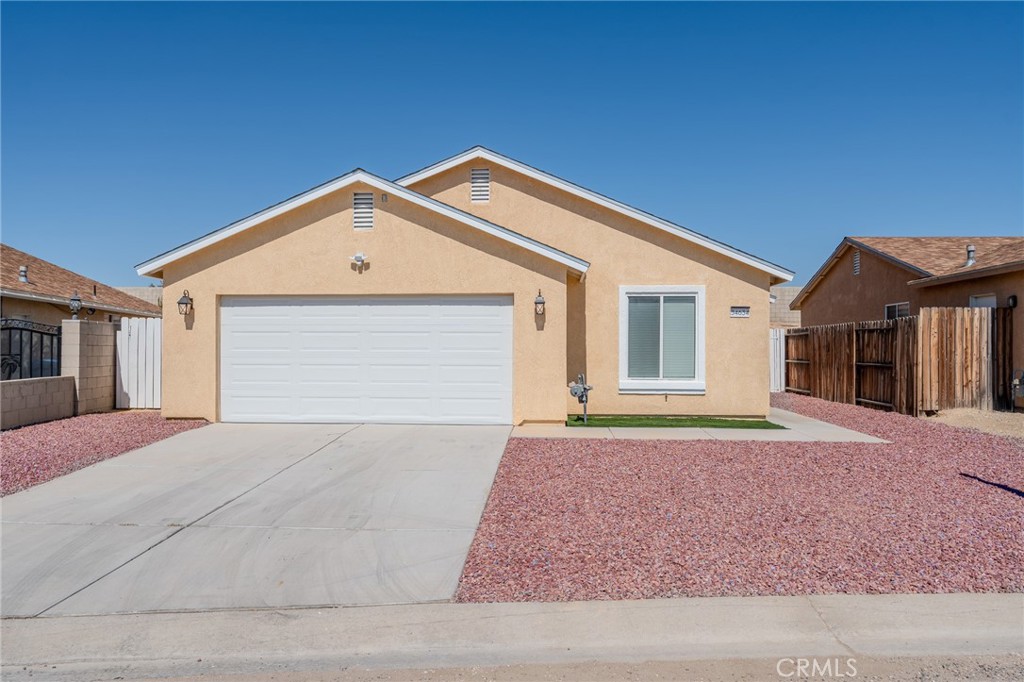 34634 Pso Del Valle Barstow, CA 92311 - Photo 25 of 37 a front view of a house with a yard and garage