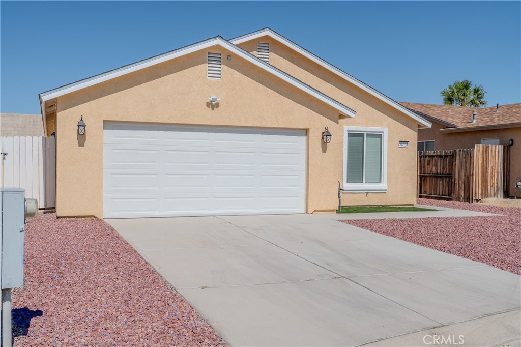 34634 Pso Del Valle Barstow, CA 92311 - Photo 26 of 37 a front view of a house with a yard and garage