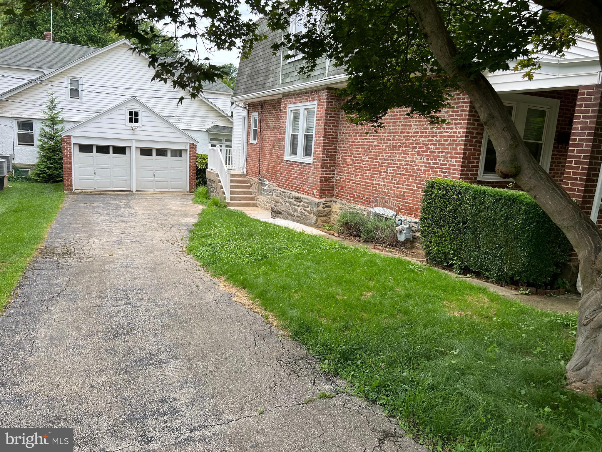 342 Dudley Avenue Narberth, PA 19072 - Photo 2 of 3 a front view of a house with a yard and garage