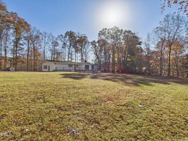 a view of swimming pool with outdoor seating and yard in the back