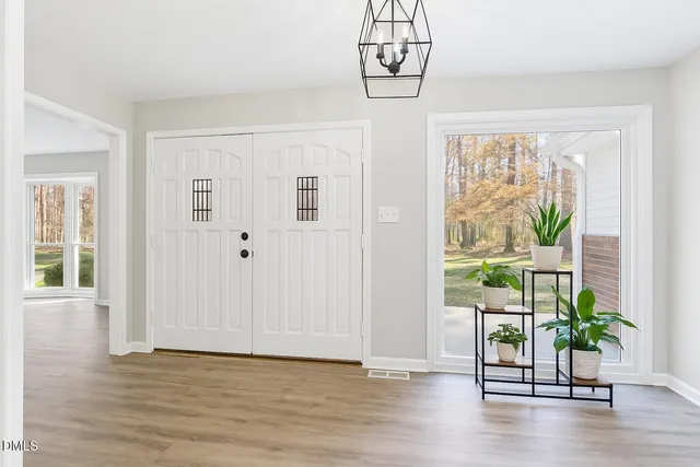 a view of a room with wooden floor and windows