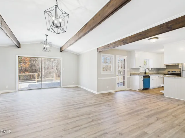 a view of a kitchen with wooden floor and a kitchen
