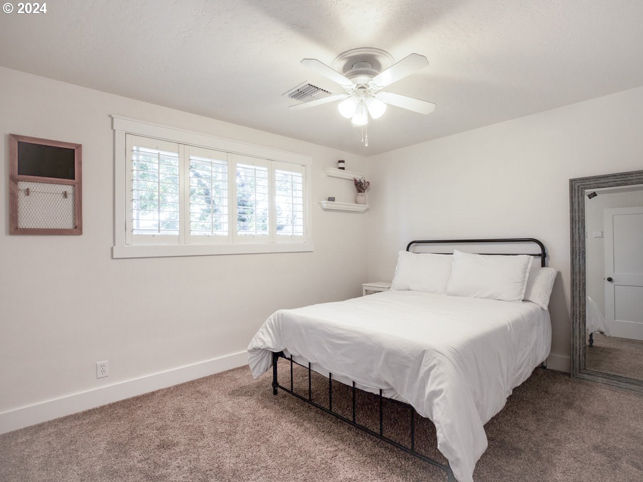 1440 Fetlock Court Eugene, OR 97401 - Photo 14 of 31 a bedroom with a bed and a chandelier