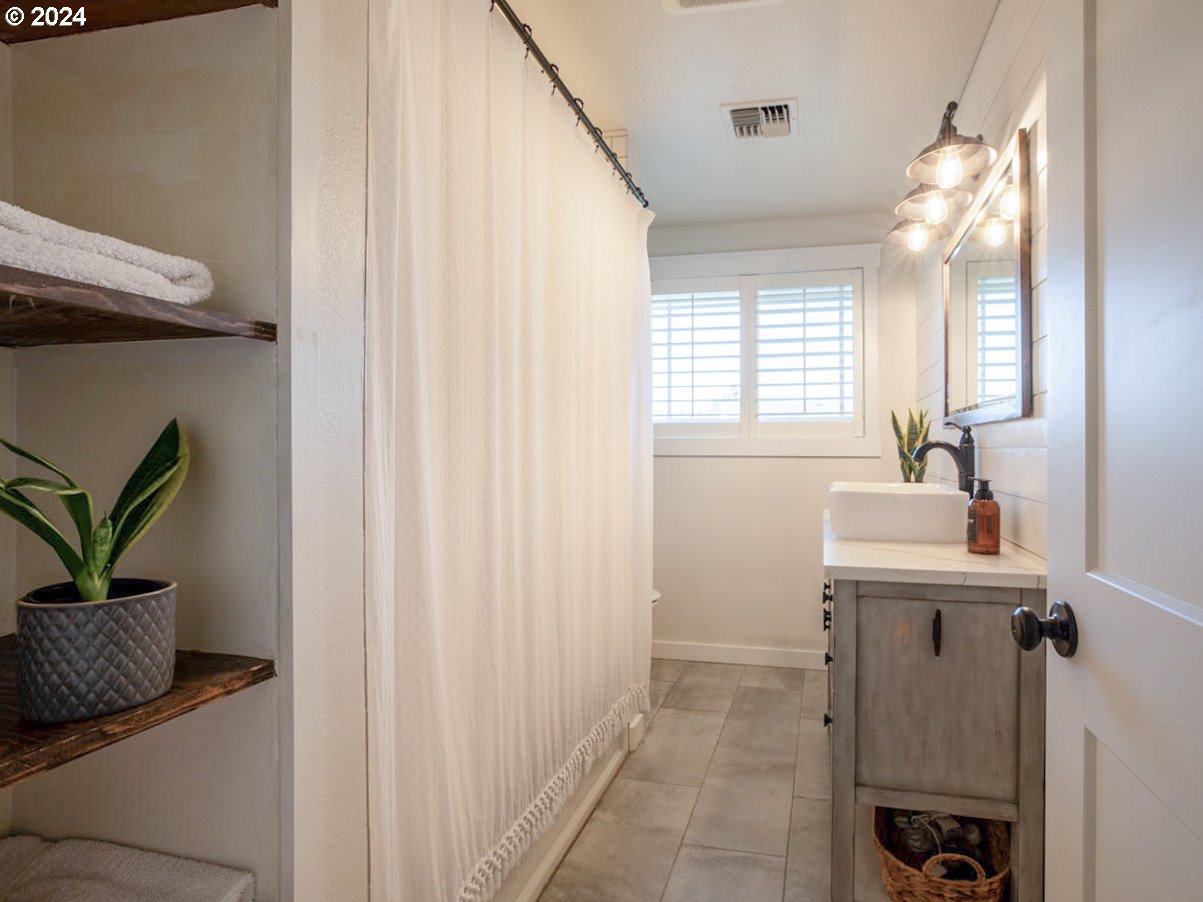 1440 Fetlock Court Eugene, OR 97401 - Photo 15 of 31 a bathroom with a sink a mirror and a window