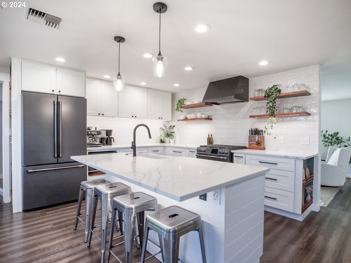 1440 Fetlock Court Eugene, OR 97401 - Photo 5 of 31 a kitchen with stainless steel appliances a sink a stove a refrigerator and cabinets