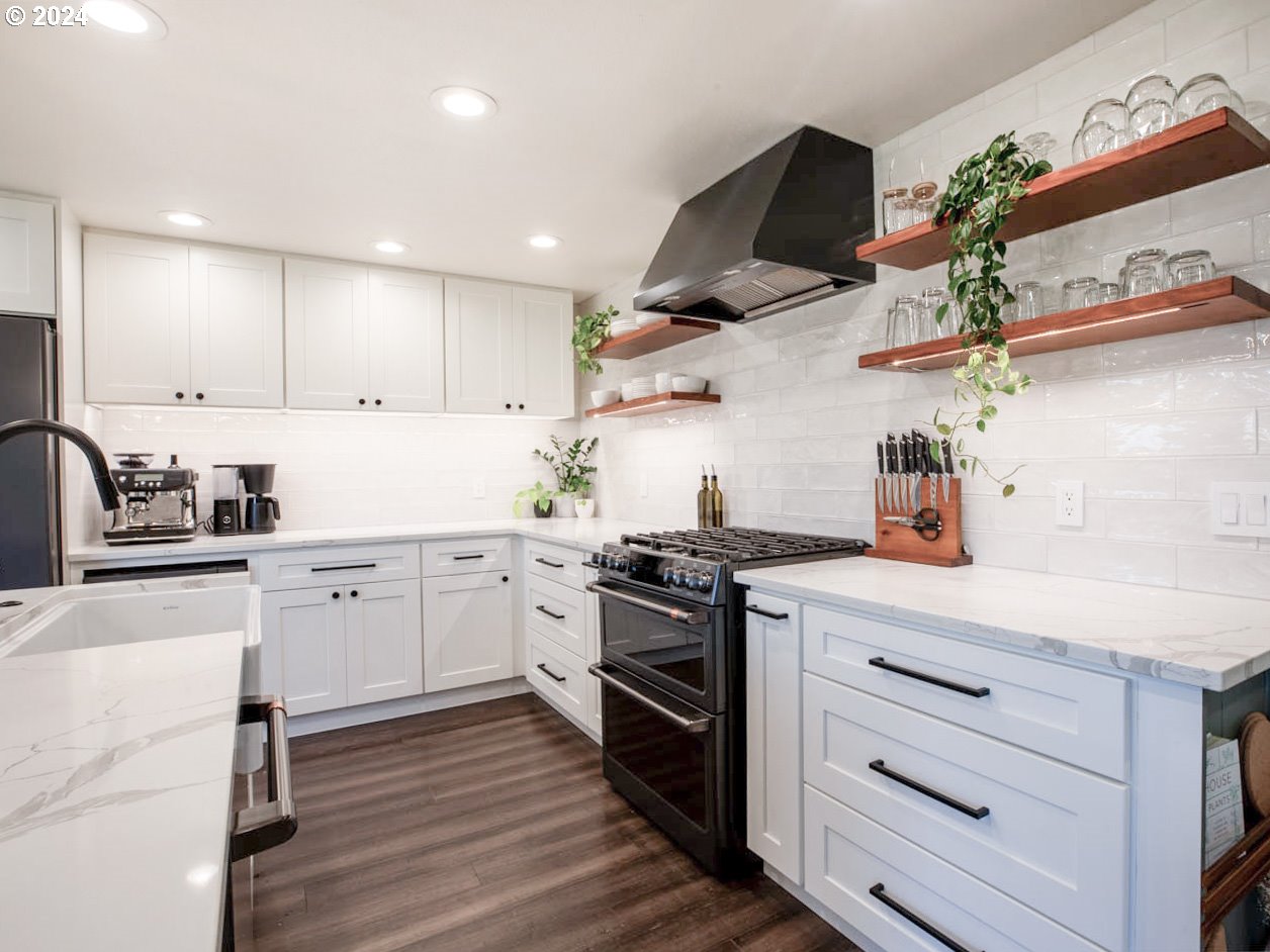 1440 Fetlock Court Eugene, OR 97401 - Photo 6 of 31 a kitchen with granite countertop cabinets stainless steel appliances and wooden floor