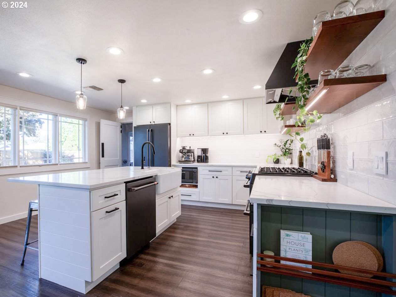 1440 Fetlock Court Eugene, OR 97401 - Photo 8 of 31 a kitchen with stainless steel appliances granite countertop a sink a stove and a wooden floors