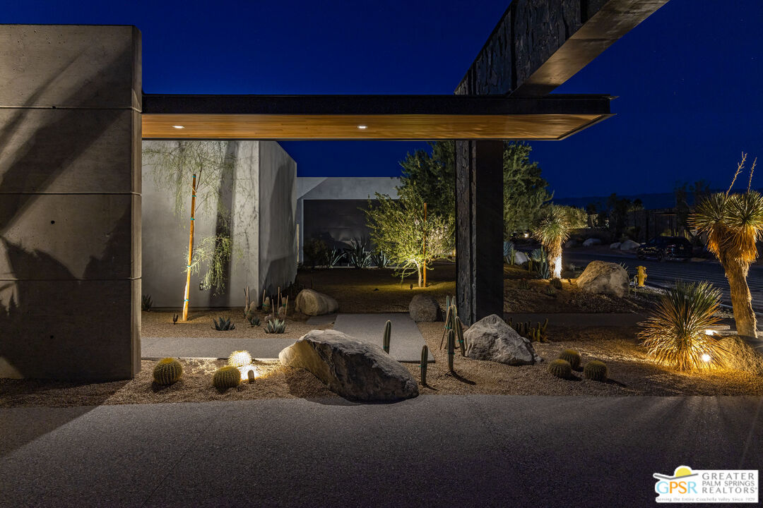 1 Echo Lane Rancho Mirage, CA 92270 - Photo 15 of 51 a view of a patio with table and chairs under an umbrella