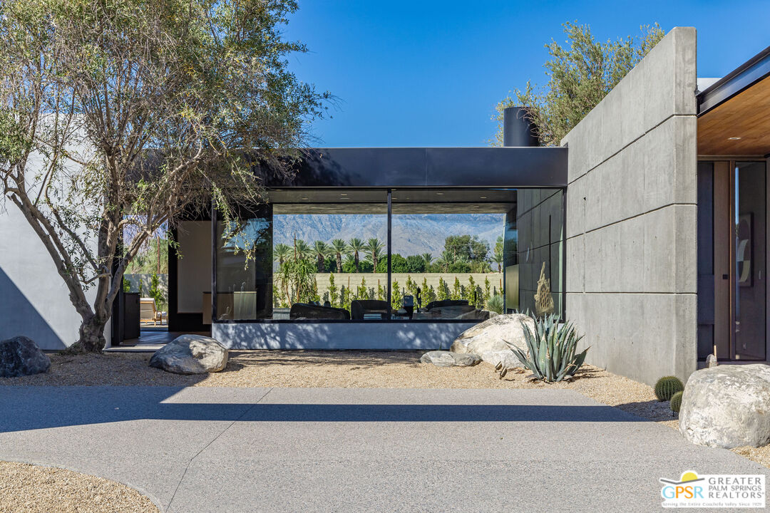 1 Echo Lane Rancho Mirage, CA 92270 - Photo 18 of 51 a view of a house with a large tree and a yard