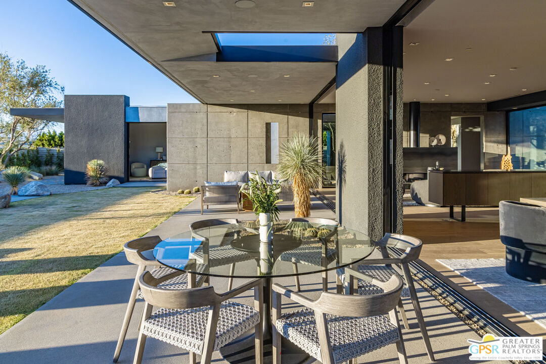 1 Echo Lane Rancho Mirage, CA 92270 - Photo 34 of 51 a view of a patio with dining table and chairs with wooden floor