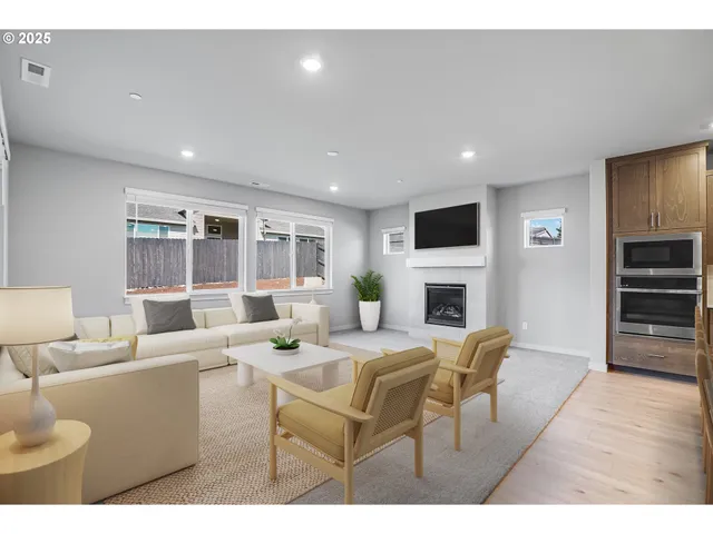 a living room with furniture a fireplace and a flat screen tv