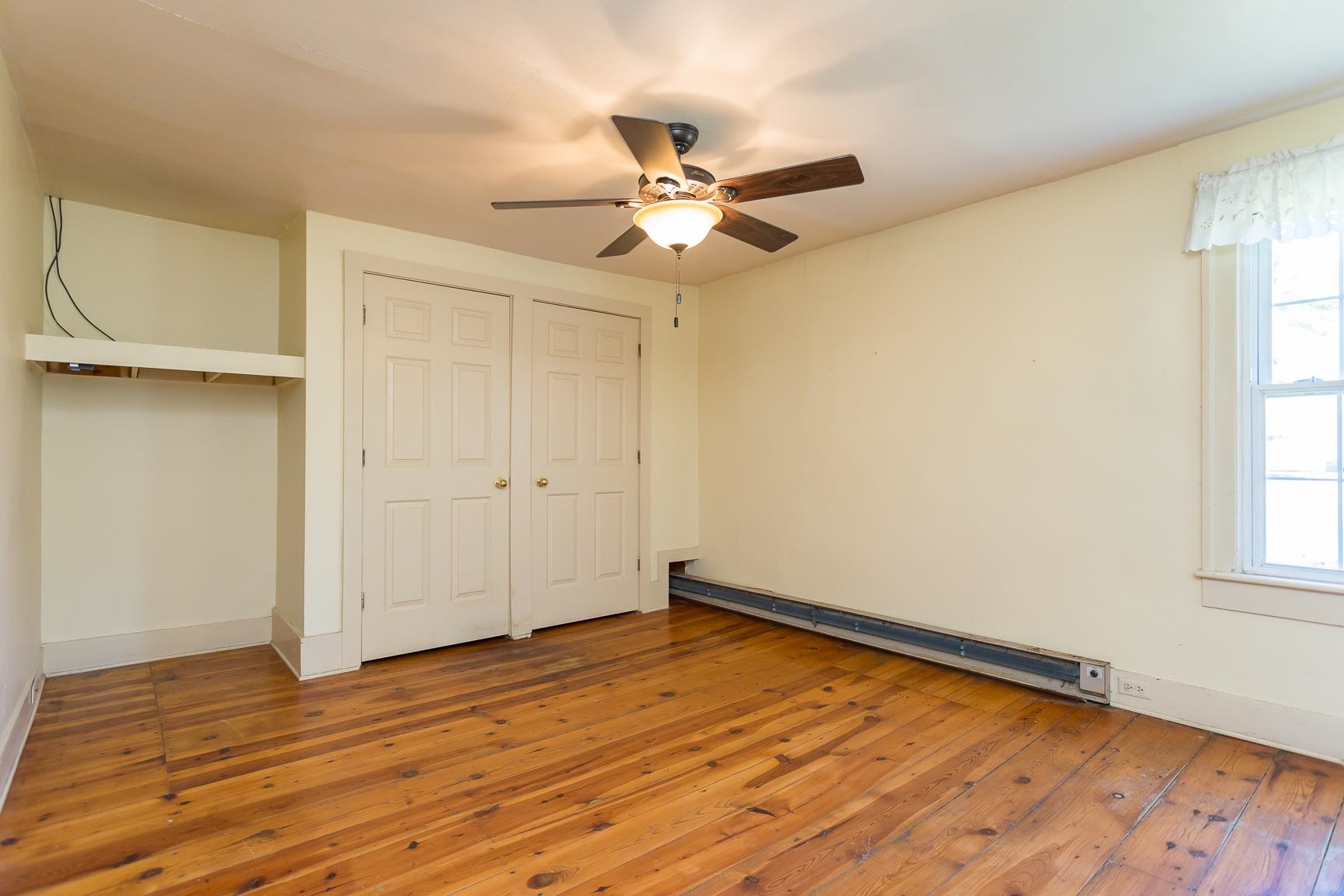 3756 Middlebrook Village Road Middlebrook, VA 24459 - Photo 31 of 41 an empty room with wooden floor fan and windows