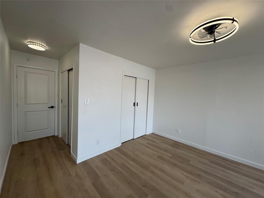 5510 Boca Raton Boulevard, Unit 431 Fort Worth, TX 76112 - Photo 11 of 19 a view of empty room with wooden floor