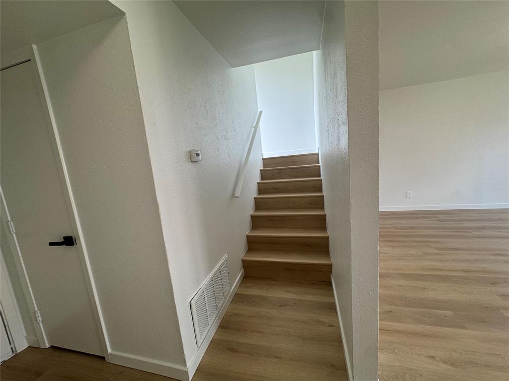 5510 Boca Raton Boulevard, Unit 431 Fort Worth, TX 76112 - Photo 15 of 19 a view of staircase with white walls and white door