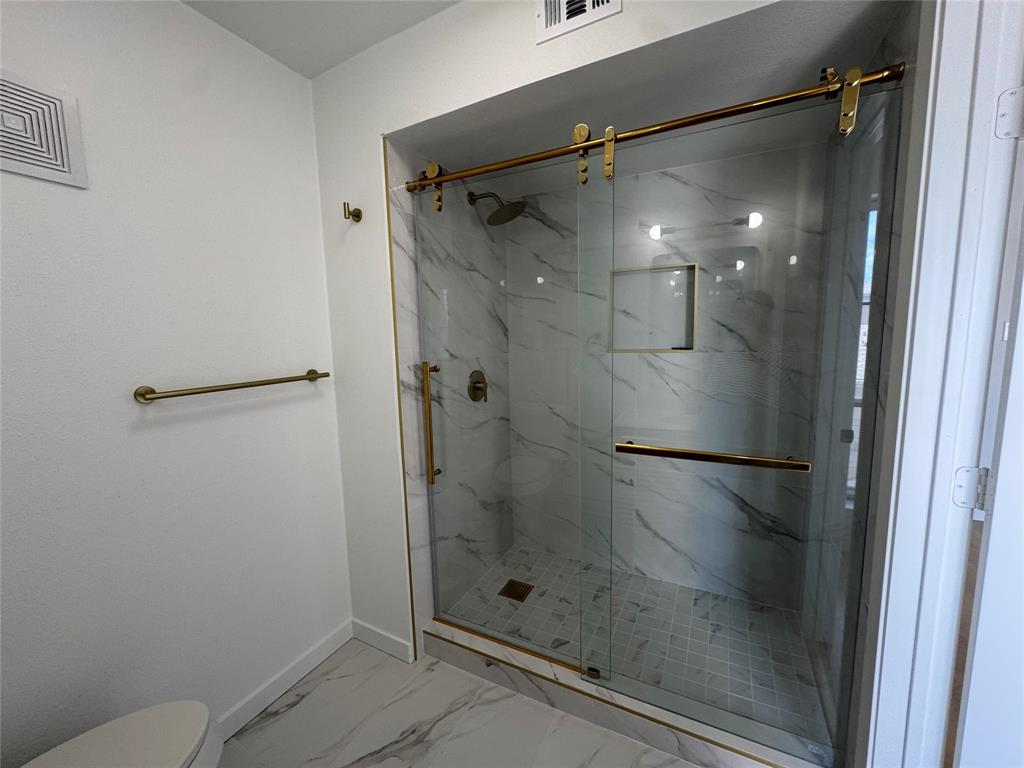 5510 Boca Raton Boulevard, Unit 431 Fort Worth, TX 76112 - Photo 16 of 19 a bathroom with a glass shower door