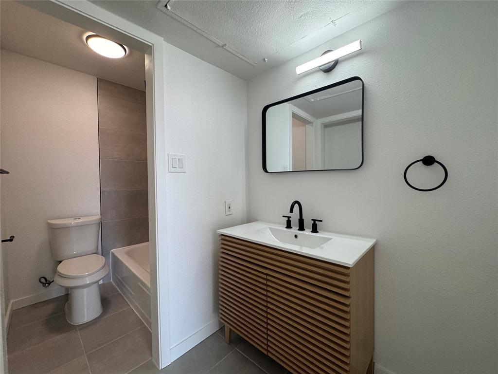 5510 Boca Raton Boulevard, Unit 431 Fort Worth, TX 76112 - Photo 18 of 19 a bathroom with a toilet sink and mirror