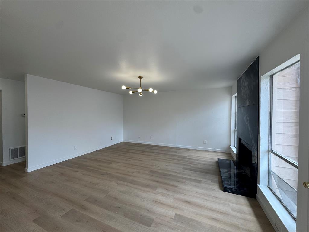 5510 Boca Raton Boulevard, Unit 431 Fort Worth, TX 76112 - Photo 2 of 19 a view of empty room with wooden floor and fan