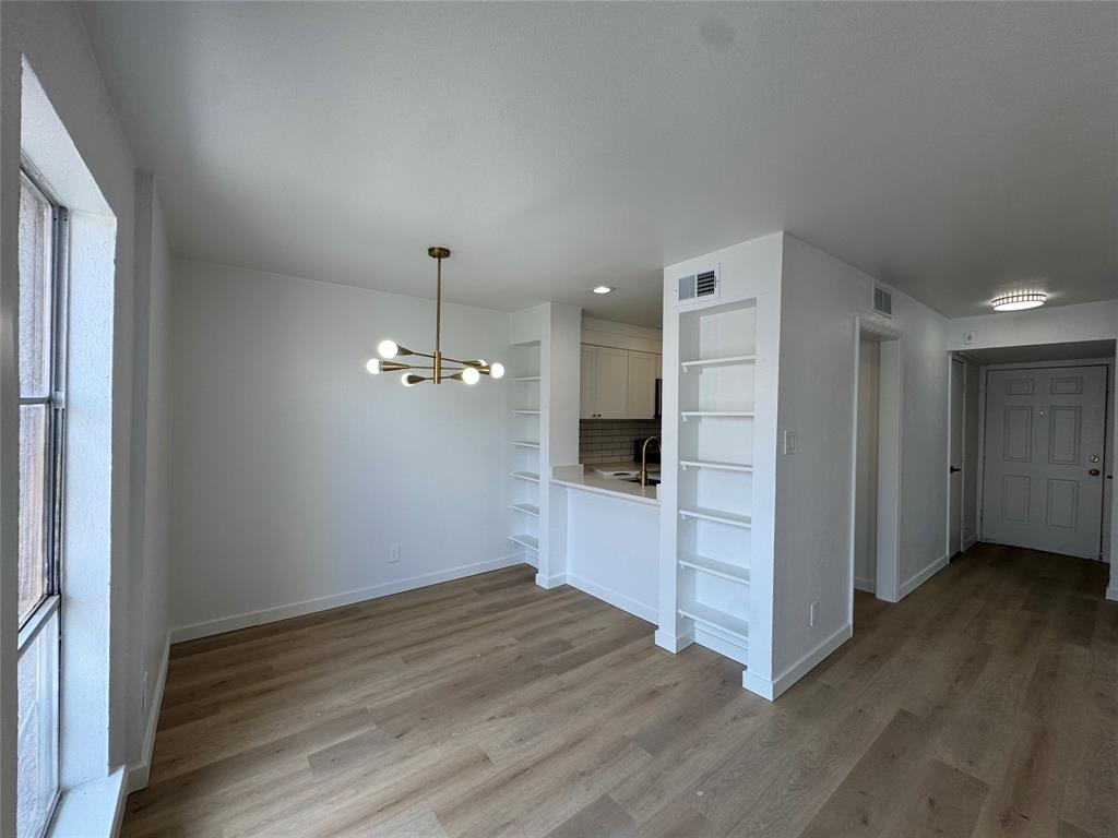 5510 Boca Raton Boulevard, Unit 431 Fort Worth, TX 76112 - Photo 3 of 19 a view of a kitchen with wooden floor and a refrigerator