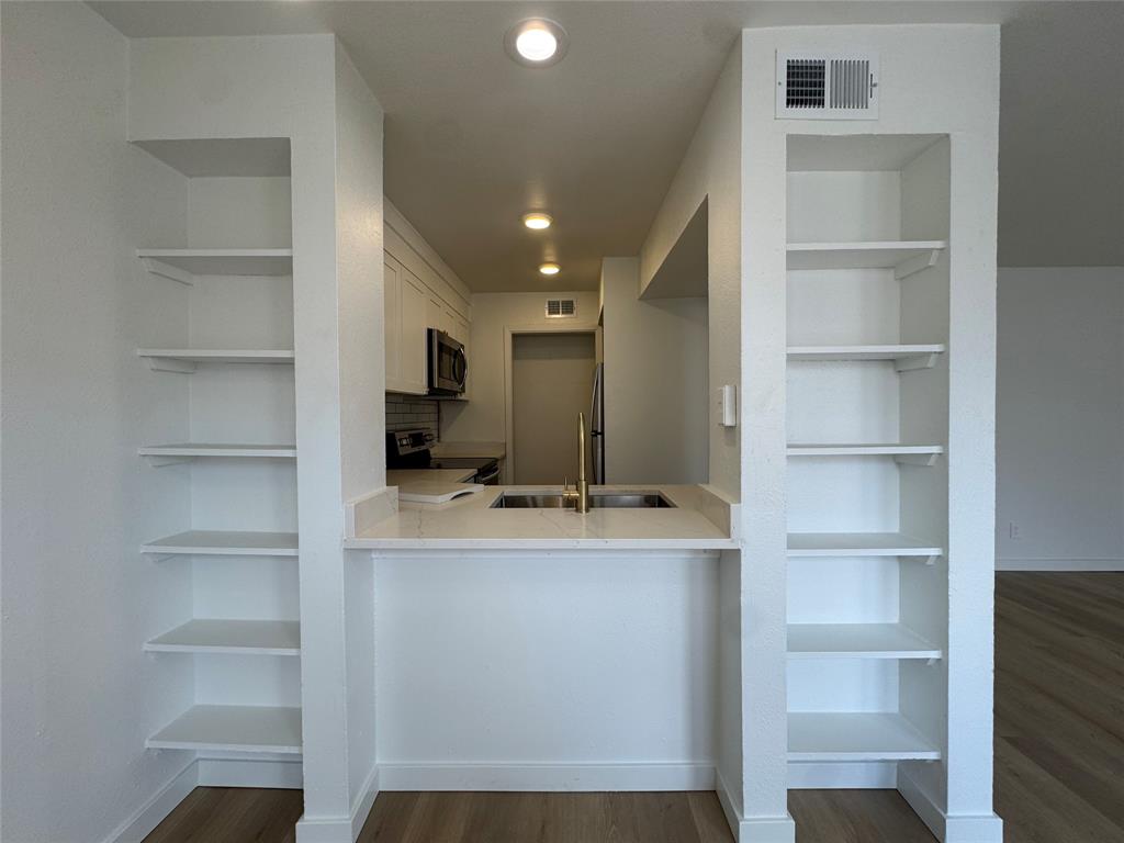 5510 Boca Raton Boulevard, Unit 431 Fort Worth, TX 76112 - Photo 5 of 19 a room with cabinets and a flat screen tv