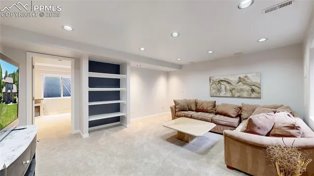 a bedroom with a bed a chandelier and a window