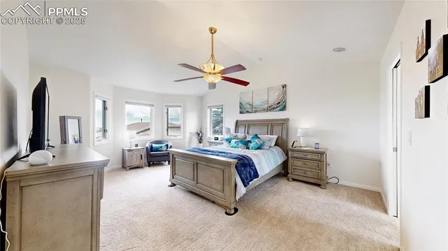 a bedroom with a bed chandelier and a window