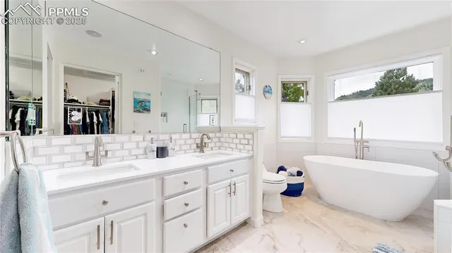 a white bath tub sitting next to a white sink