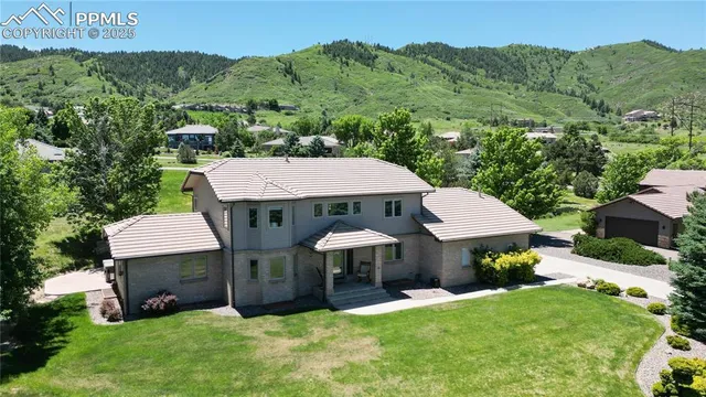 a backyard of a house with table and chairs