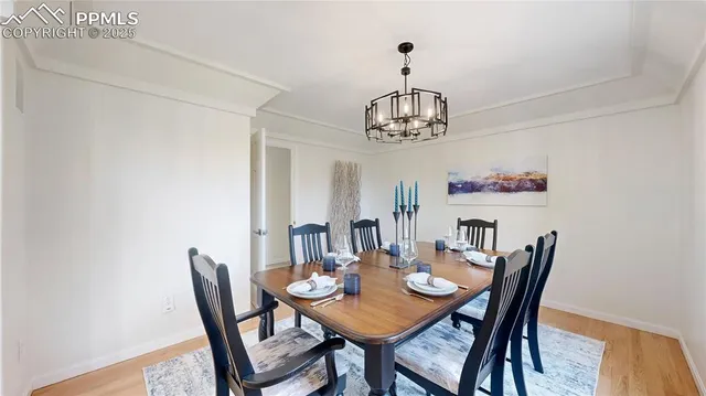 a view of a dining room with furniture wooden floor and chandelier