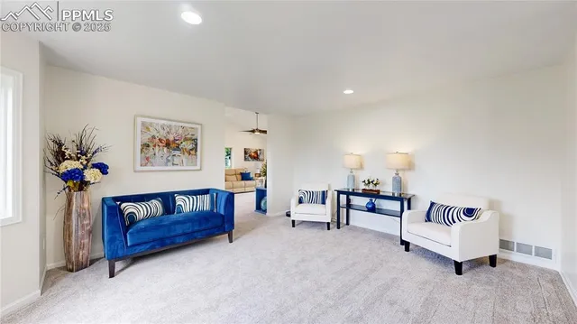 a living room with furniture and a potted plant