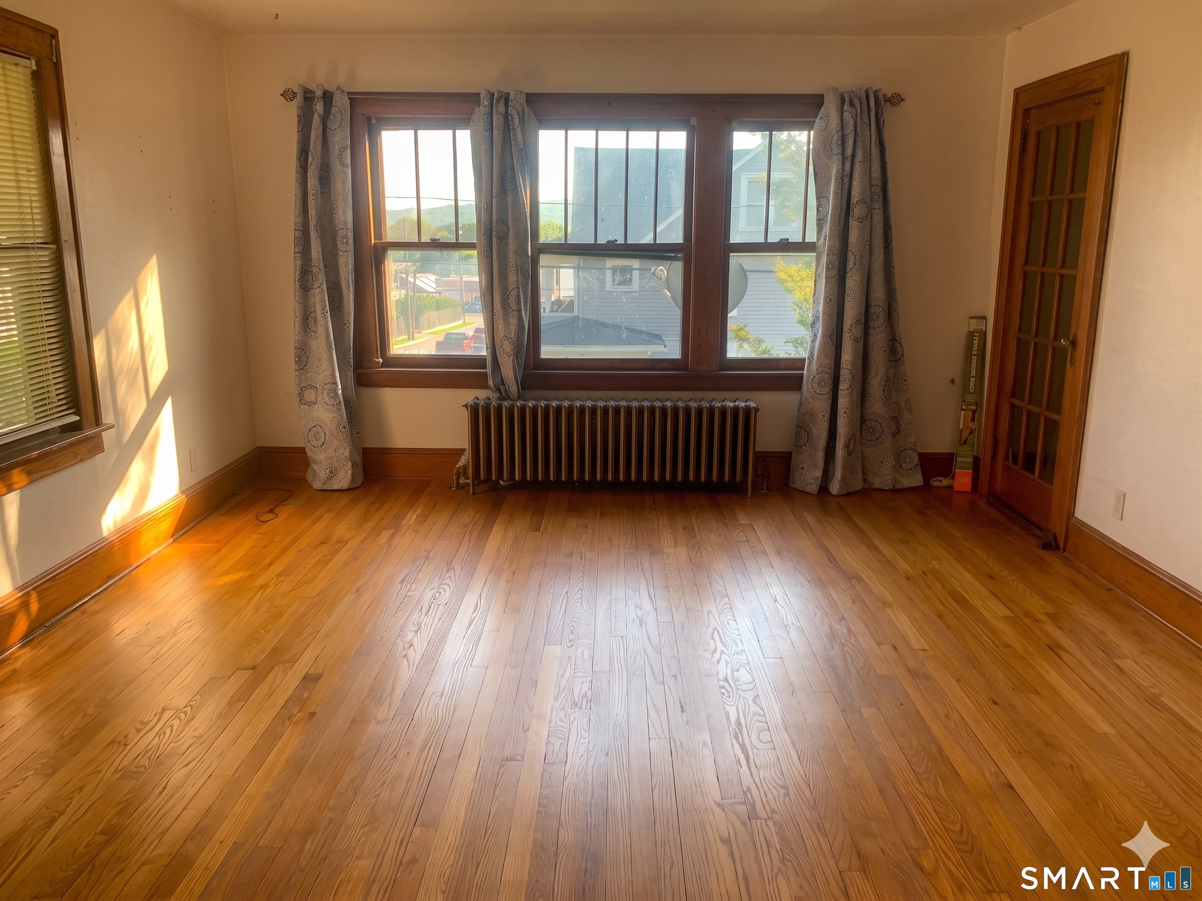 44 Bird Street Torrington, CT 06790 - Photo 9 of 17 a view of an empty room with wooden floor and a window
