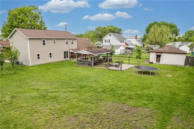 a view of a house with a yard and sitting area
