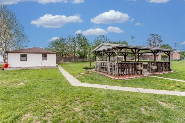 a view of a house with a yard and deck