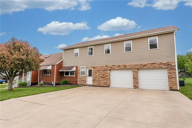 a front view of house with yard and trees