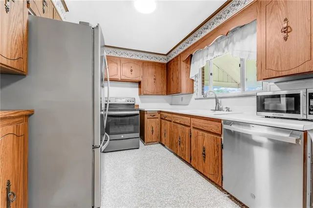 a kitchen with stainless steel appliances a refrigerator and a sink