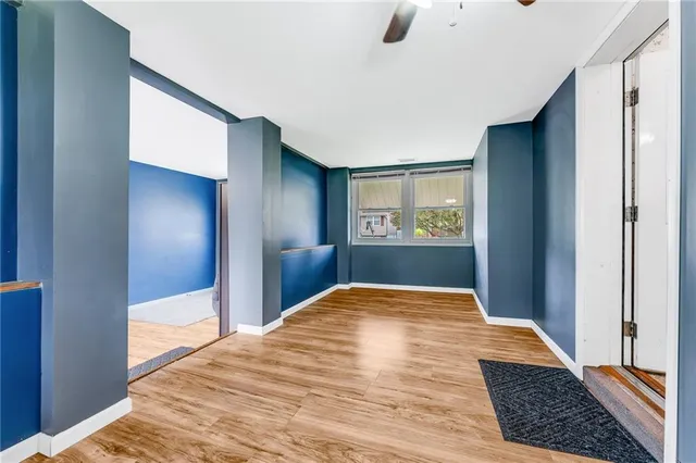 a view of hallway with bedroom and wooden floor