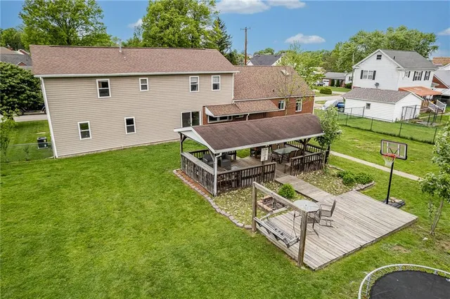 an aerial view of a house with backyard