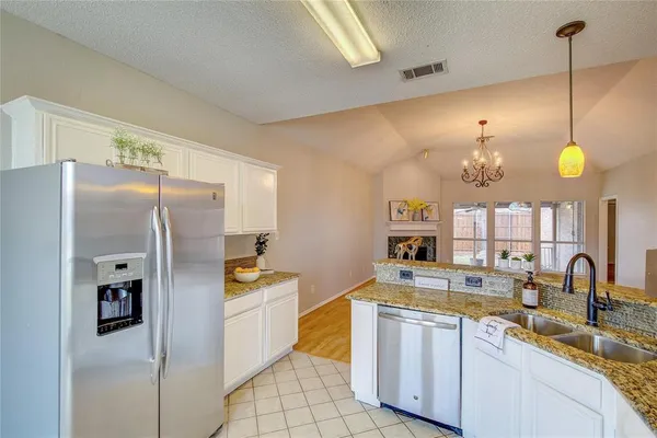 a kitchen with a sink stainless steel appliances and cabinets