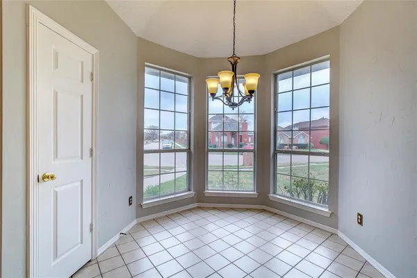 a view of entryway with wooden floor and chandelier