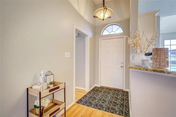 a view of an entryway with wooden floor