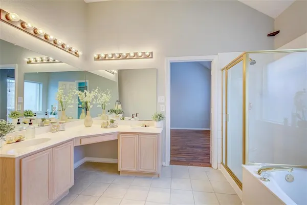 a bathroom with a sink a mirror and a bathtub