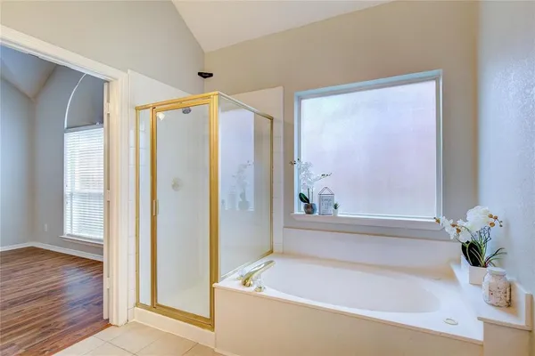 a bathroom with a bathtub and a shower