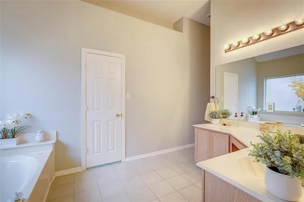 a room with a sink and a mirror