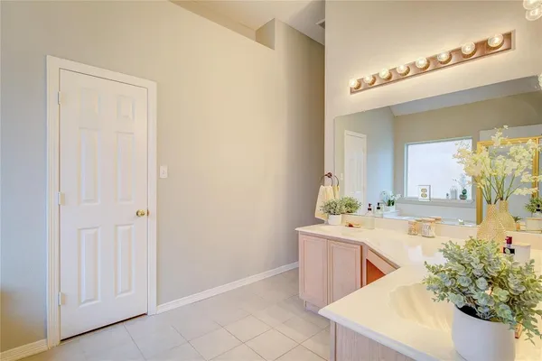 a room with a sink and a mirror