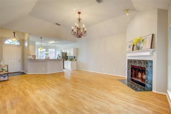 a view of an empty room with a fireplace