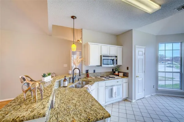 a kitchen with a stove a sink and a refrigerator