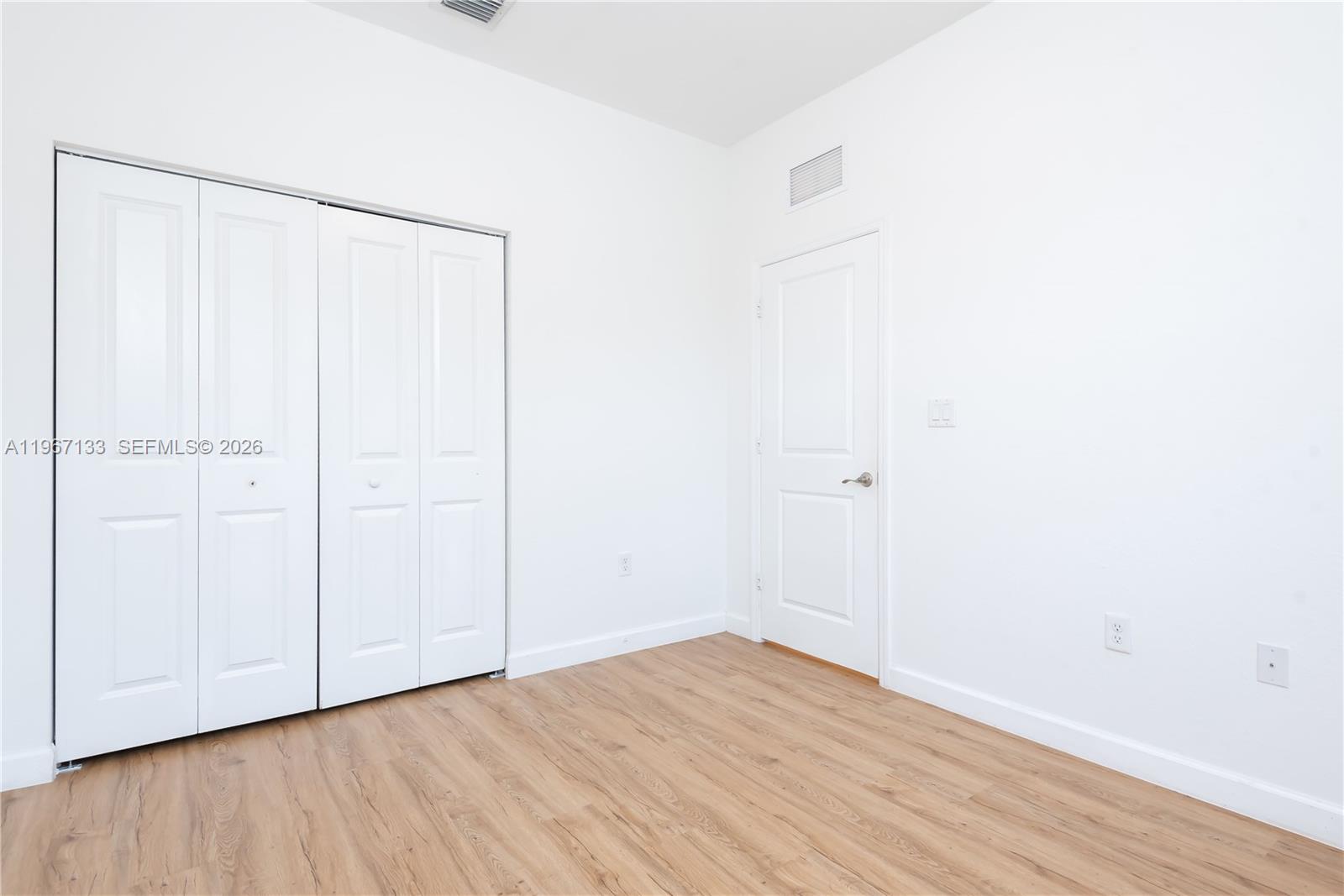 25128 Southwest 113th Place Homestead, FL 33032 - Photo 32 of 39 a view of an empty room with wooden floor