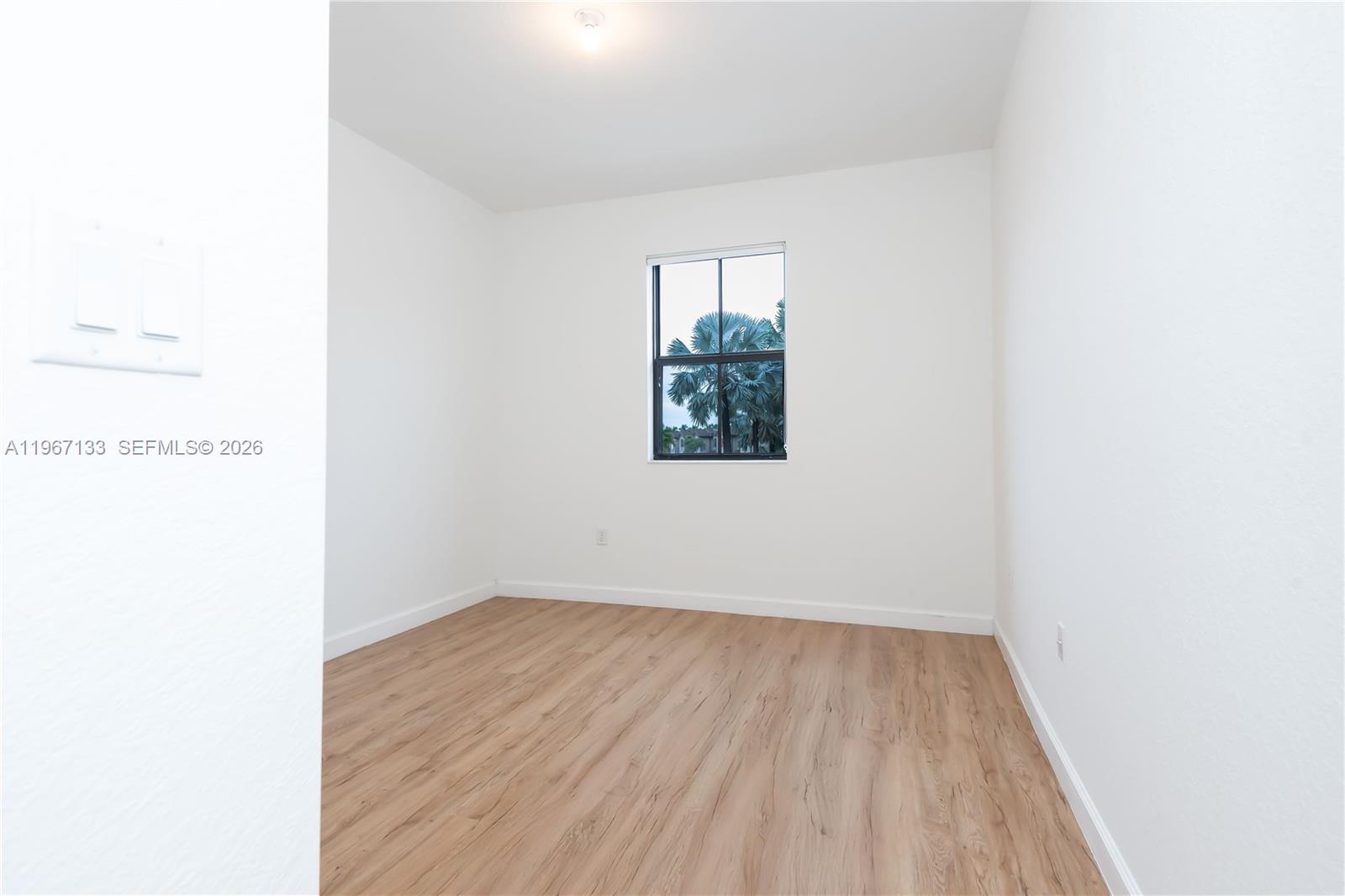 25128 Southwest 113th Place Homestead, FL 33032 - Photo 34 of 39 a view of a small space with wooden floor and a window